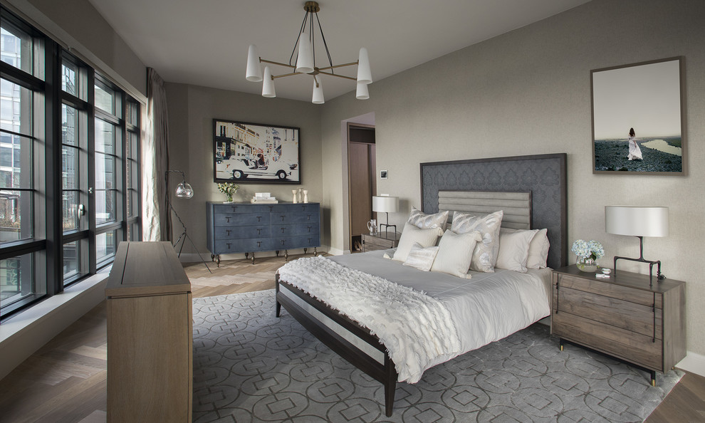 Inspiration for a contemporary master bedroom in New York with grey walls, medium hardwood floors and brown floor.