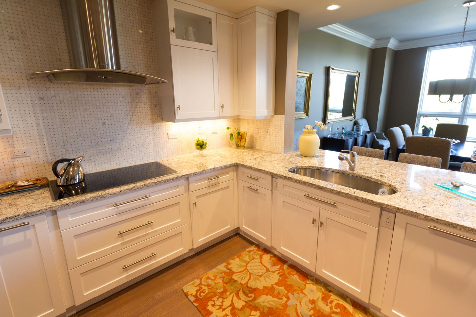 Example of a large transitional u-shaped brown floor and medium tone wood floor open concept kitchen design in Denver with an undermount sink, shaker cabinets, white cabinets, granite countertops, white backsplash, mosaic tile backsplash, stainless steel appliances and a peninsula