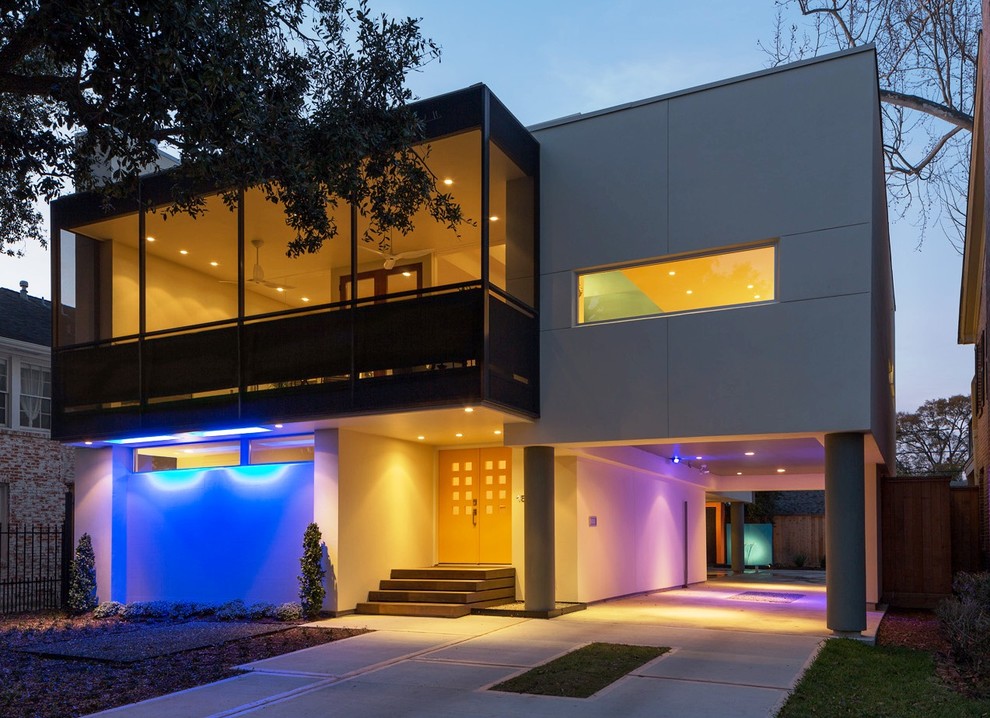 Large contemporary two-storey white house exterior in Houston with mixed siding and a flat roof.