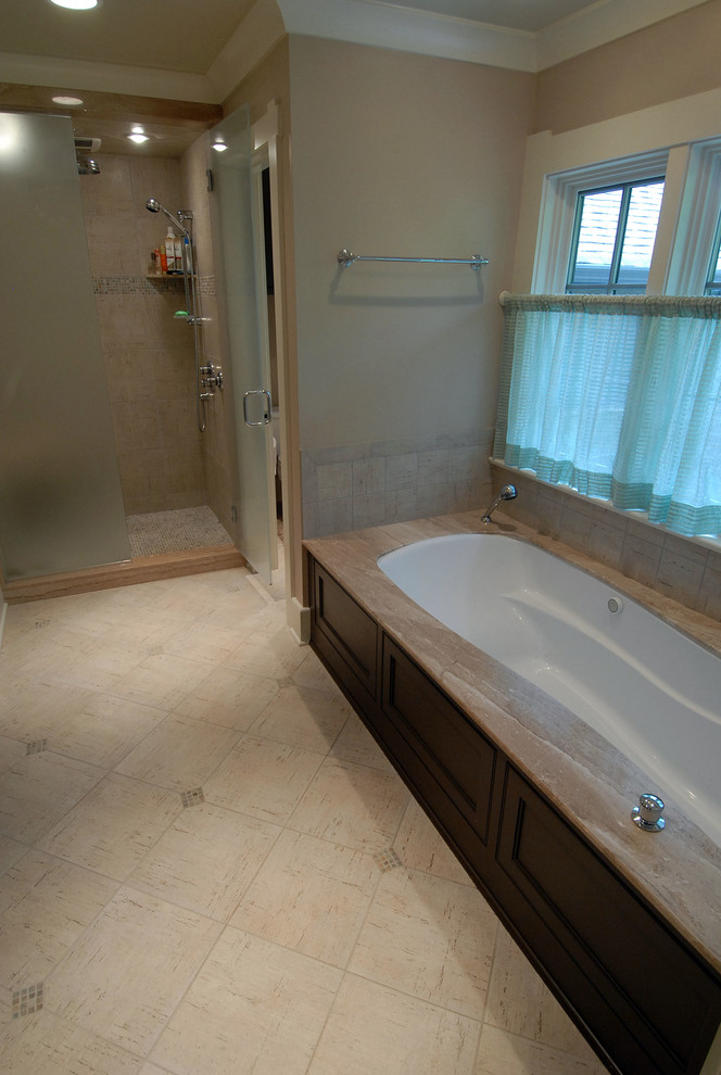 Large transitional master bathroom in Nashville with an undermount sink, shaker cabinets, dark wood cabinets, onyx benchtops, a japanese tub, an alcove shower, a one-piece toilet, beige tile, beige walls and travertine floors.