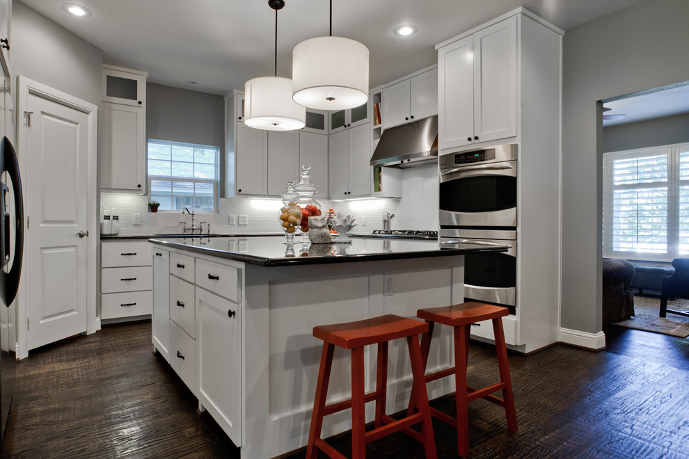 This is an example of a transitional kitchen in Dallas with stainless steel appliances.