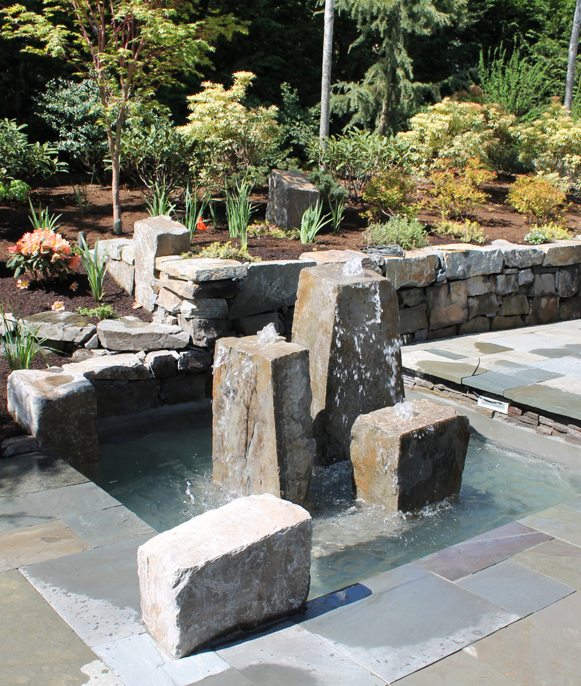 Inspiration for a contemporary water fountain landscape in Seattle.