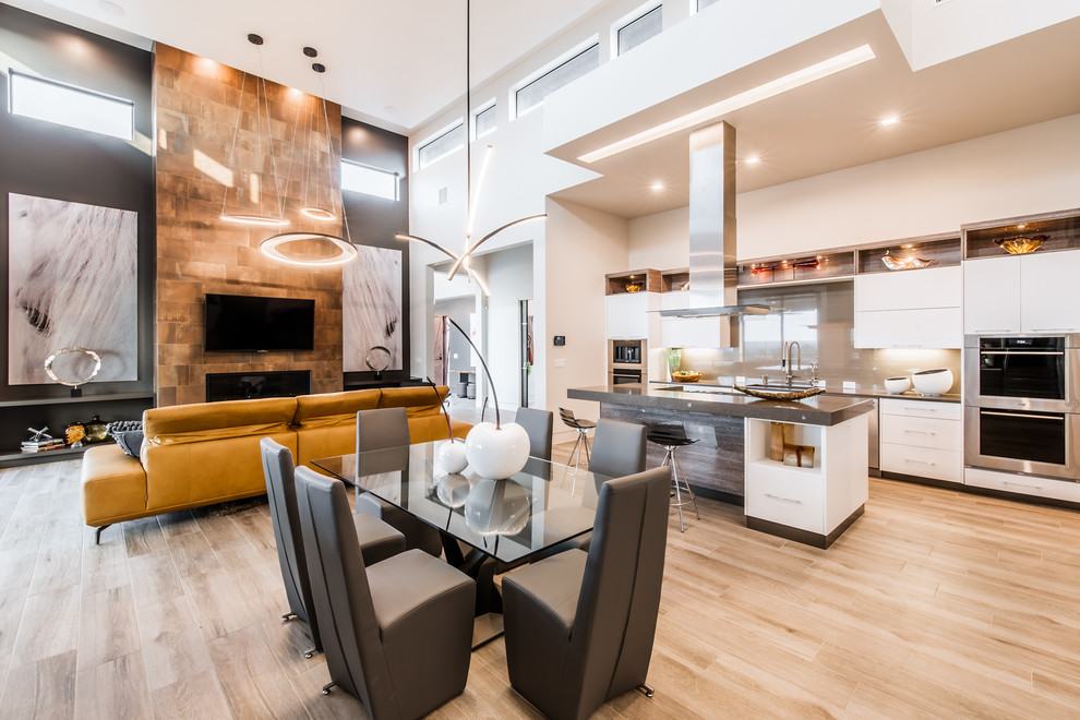 This is an example of a large modern open plan dining in Austin with beige walls, light hardwood floors, no fireplace and brown floor.