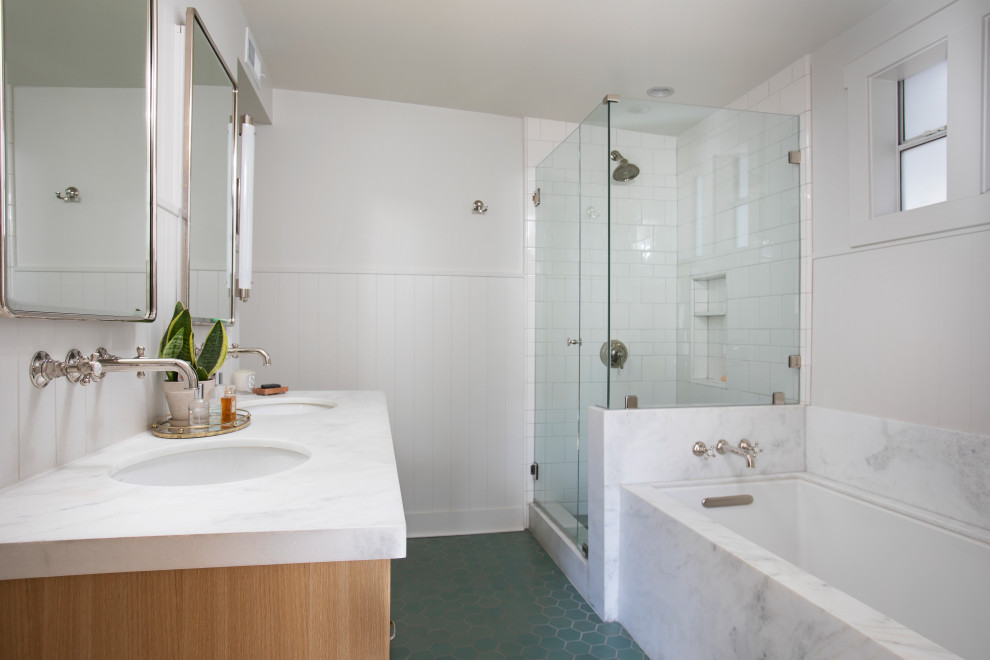 Design ideas for a medium sized traditional ensuite bathroom in Los Angeles with flat-panel cabinets, light wood cabinets, a submerged bath, a corner shower, a one-piece toilet, white tiles, ceramic tiles, white walls, ceramic flooring, a submerged sink, marble worktops, green floors, a hinged door, white worktops, double sinks, a floating vanity unit and tongue and groove walls.