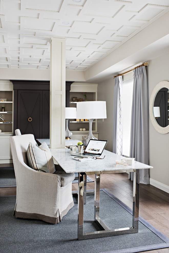 Photo of a large contemporary home office in Toronto with grey walls, medium hardwood floors, no fireplace and a freestanding desk.