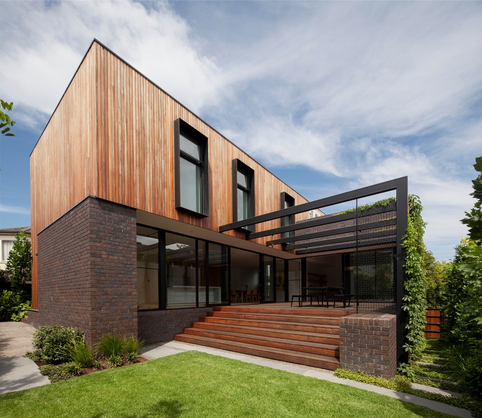 Contemporary two-storey house exterior in Sydney with mixed siding and a flat roof.