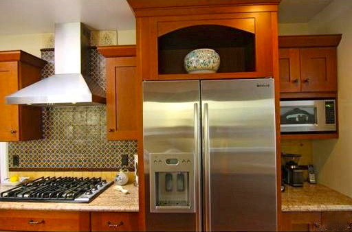 Small tropical galley separate kitchen in Phoenix with an undermount sink, shaker cabinets, medium wood cabinets, granite benchtops, ceramic splashback, stainless steel appliances, multi-coloured splashback and no island.