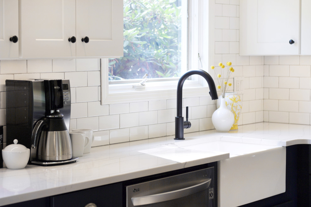 Eat-in kitchen - transitional eat-in kitchen idea with a farmhouse sink, shaker cabinets, white cabinets, quartz countertops, white backsplash, subway tile backsplash, stainless steel appliances, an island and white countertops