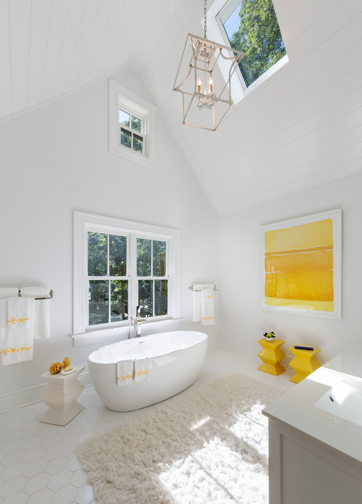 Design ideas for a large traditional master bathroom in New York with shaker cabinets, white cabinets, a freestanding tub, white tile, white walls and an integrated sink.