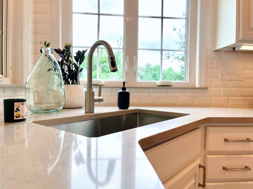 Large transitional u-shaped ceramic tile and beige floor open concept kitchen photo with an undermount sink, recessed-panel cabinets, white cabinets, quartz countertops, white backsplash, ceramic backsplash, stainless steel appliances, an island and gray countertops
