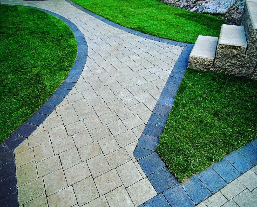 Photo of a traditional backyard concrete paver landscaping in Vancouver.