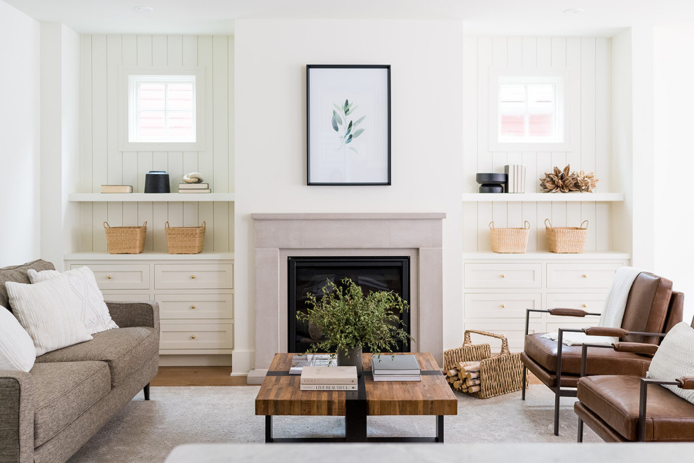 Example of a small transitional open concept medium tone wood floor, brown floor and shiplap wall living room design in Indianapolis with white walls, a standard fireplace and a stone fireplace