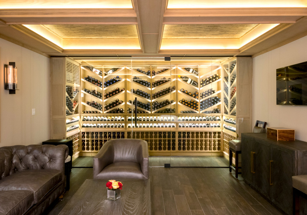 Photo of a transitional wine cellar in New York with storage racks and brown floor.