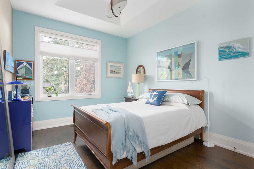 Photo of a beach style bedroom in Toronto with blue walls, dark hardwood floors and brown floor.
