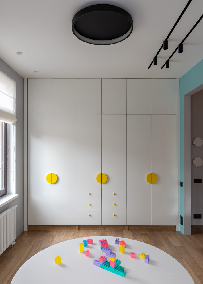 Inspiration pour une chambre d'enfant de 4 à 10 ans design de taille moyenne avec un mur multicolore, un sol en bois brun et un sol marron.