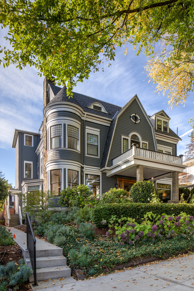 Inspiration for a traditional two-storey grey house exterior in Portland with a gambrel roof and a shingle roof.