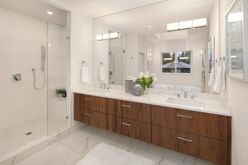 Design ideas for a contemporary master bathroom in Seattle with flat-panel cabinets, medium wood cabinets, a freestanding tub, an alcove shower, white tile, white walls, an undermount sink, multi-coloured floor, a hinged shower door, grey benchtops, a shower seat, an enclosed toilet, a double vanity and a built-in vanity.