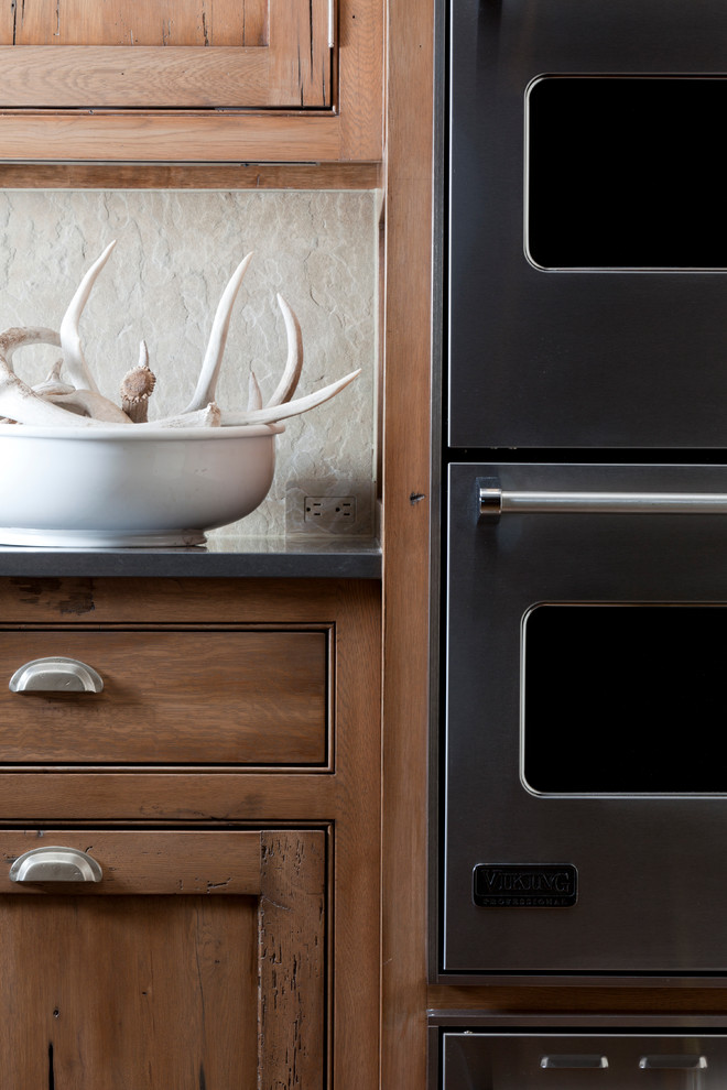 Example of a large transitional u-shaped eat-in kitchen design with beaded inset cabinets, medium tone wood cabinets, beige backsplash, stone tile backsplash, stainless steel appliances and an island