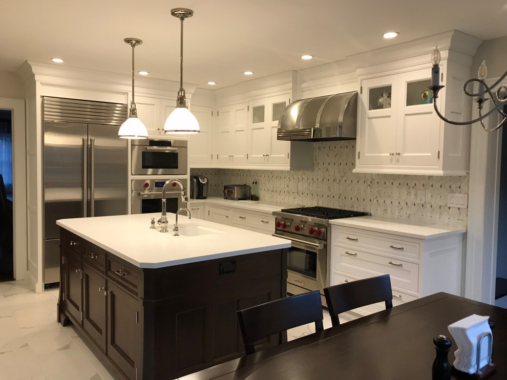 This is an example of a mid-sized transitional l-shaped eat-in kitchen in New York with an undermount sink, recessed-panel cabinets, white cabinets, quartz benchtops, white splashback, marble splashback, stainless steel appliances, marble floors, with island, white floor and white benchtop.