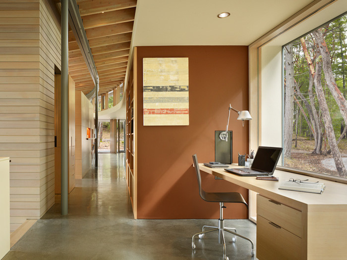 Contemporary home office in Seattle with concrete floors, a built-in desk and brown walls.