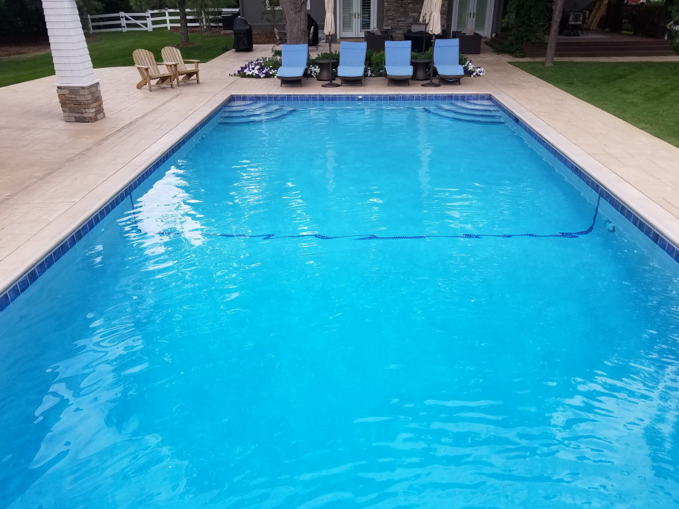 Example of a large backyard rectangular pool design in Denver