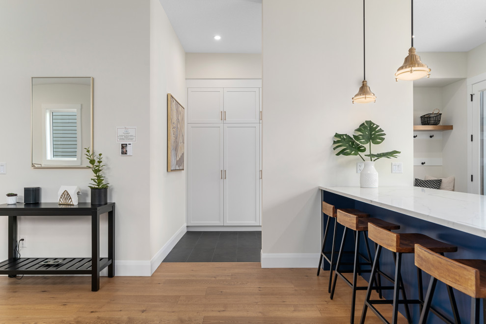 Example of a transitional home design design in Calgary