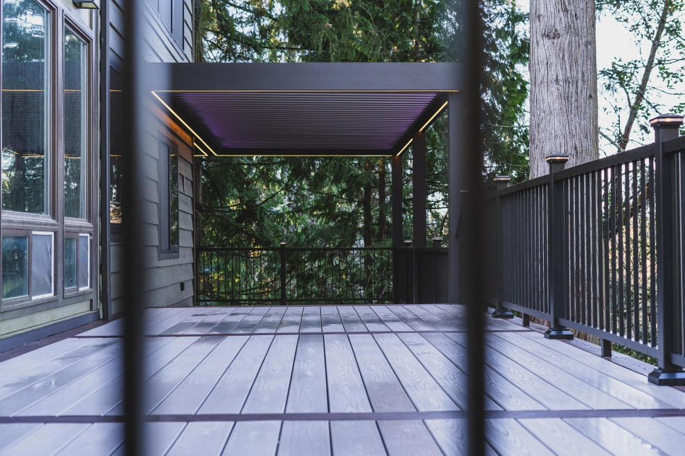 Inspiration for a large contemporary backyard second story metal railing deck remodel in Seattle with a pergola