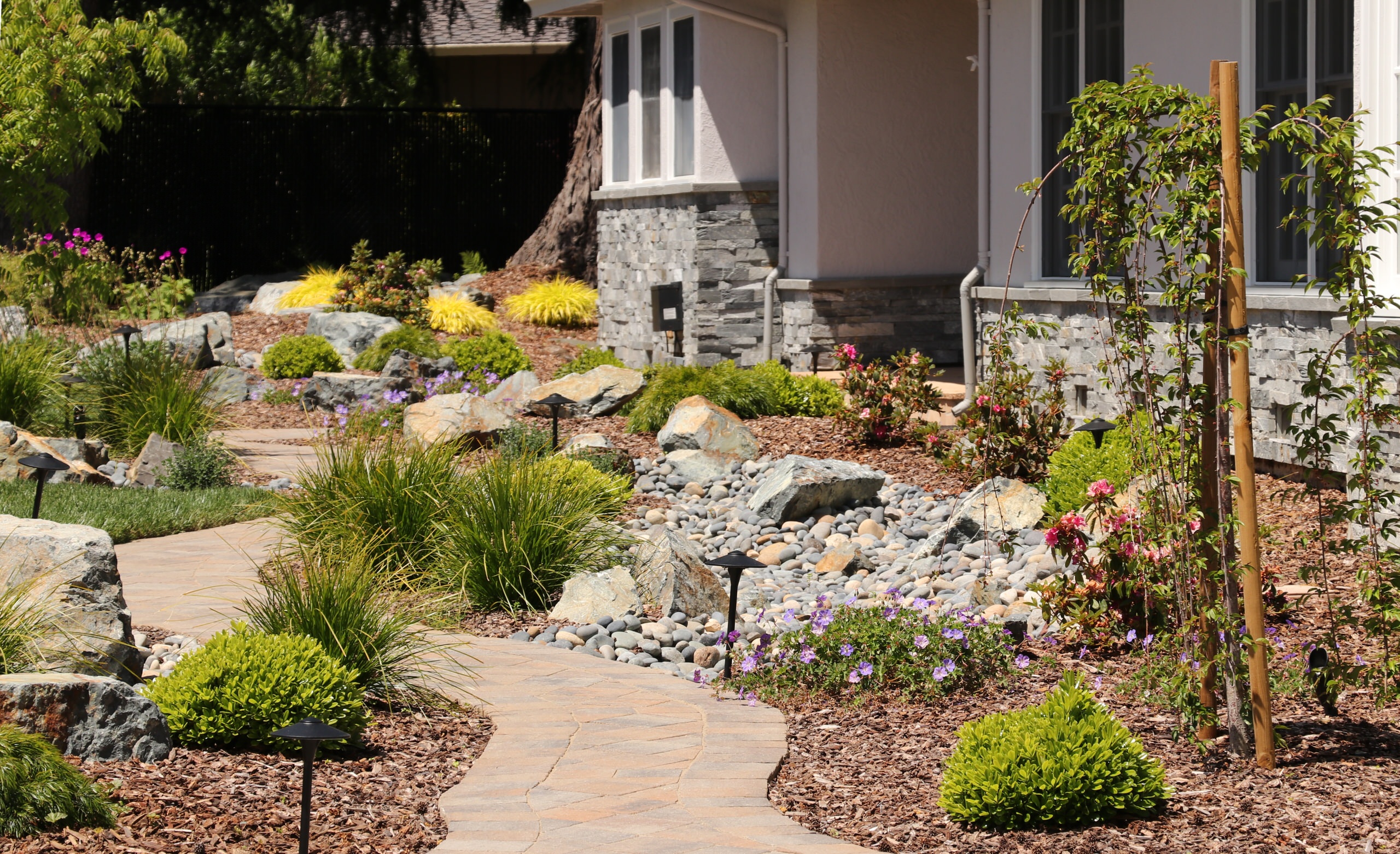 FRONT YARD WITH TREES AND DRY-CREEK