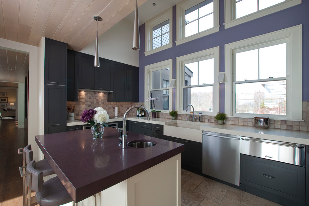 Inspiration for a mid-sized contemporary eat-in kitchen in Providence with a farmhouse sink, shaker cabinets, black cabinets, beige splashback, stainless steel appliances, with island and purple benchtop.