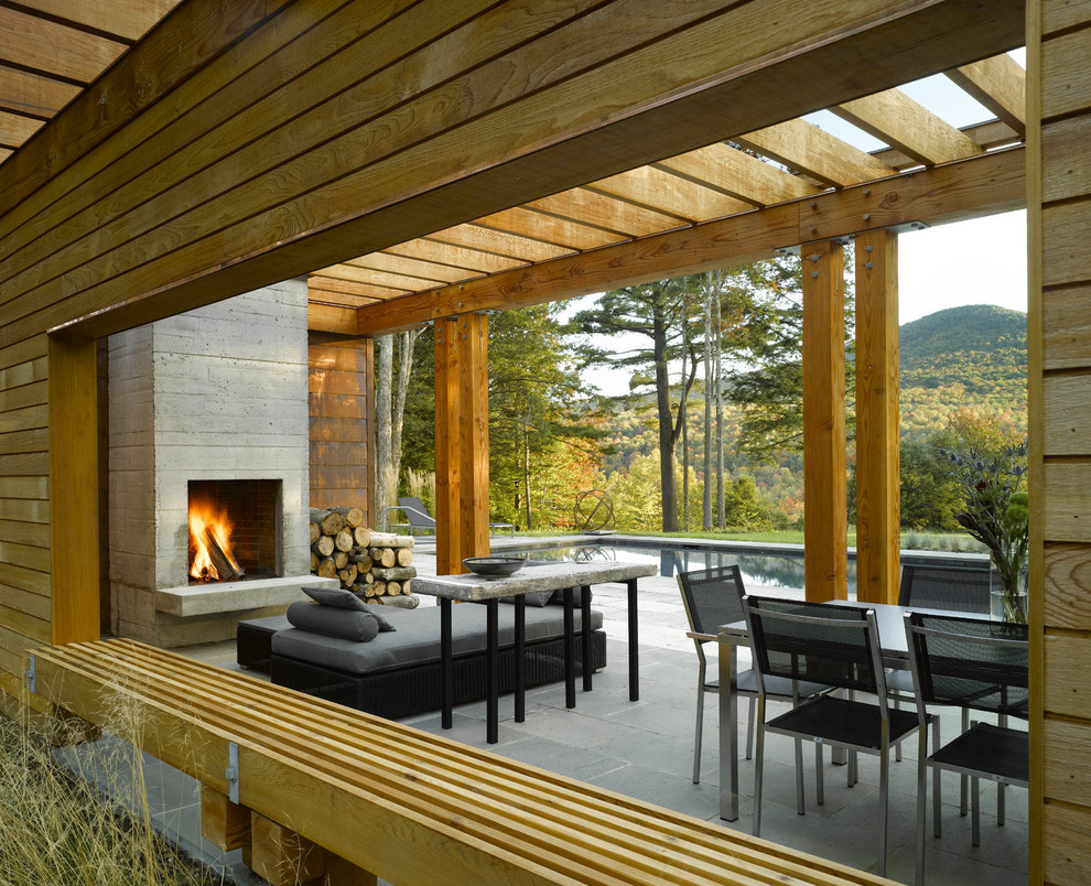 Photo of a contemporary patio in Burlington with a fire feature and a pergola.