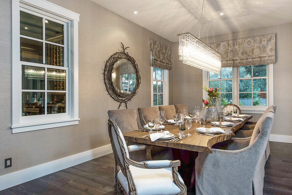 This is an example of a large country separate dining room in San Francisco with beige walls, dark hardwood floors, no fireplace and brown floor.