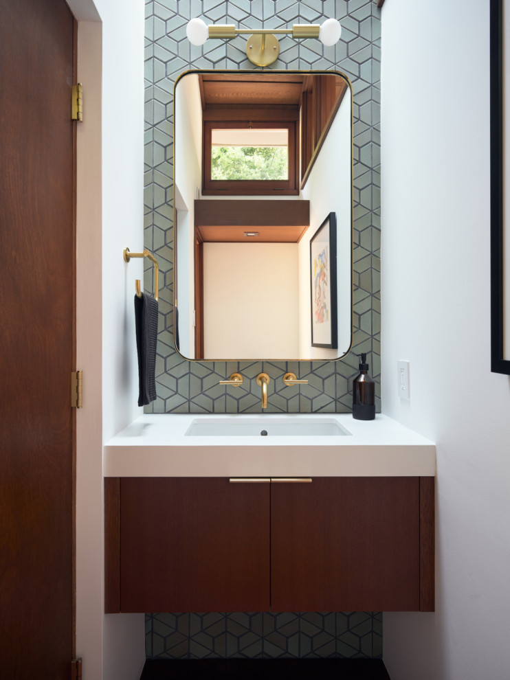 Powder room - 1950s gray tile powder room idea in San Francisco with flat-panel cabinets, dark wood cabinets, white walls, an undermount sink, white countertops and a floating vanity