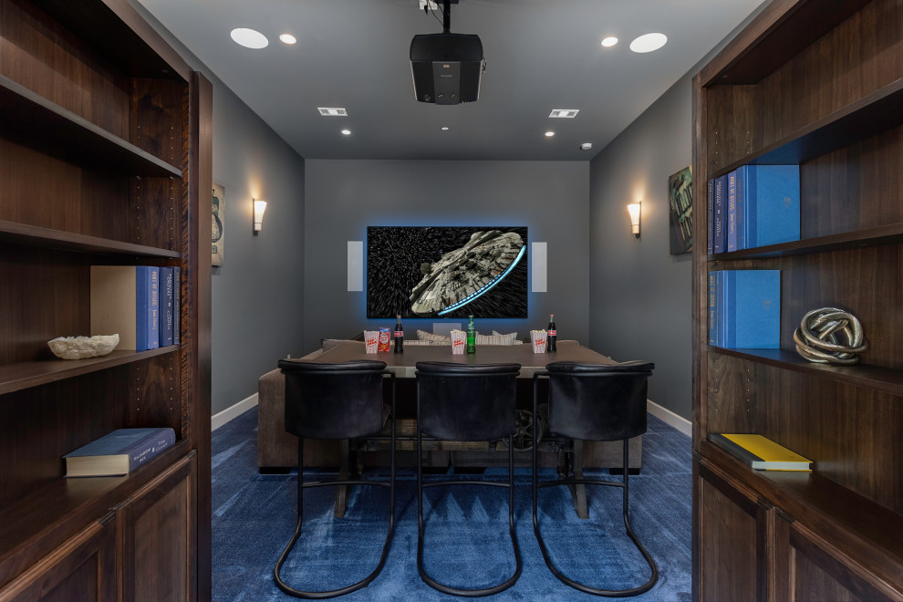 This is an example of a transitional enclosed home theatre in Austin with grey walls, carpet, a projector screen and blue floor.