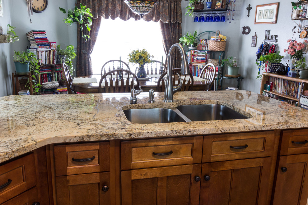 Example of a mid-sized galley cement tile floor and beige floor eat-in kitchen design with an undermount sink, shaker cabinets, medium tone wood cabinets, granite countertops, multicolored backsplash, glass sheet backsplash, stainless steel appliances, an island and beige countertops