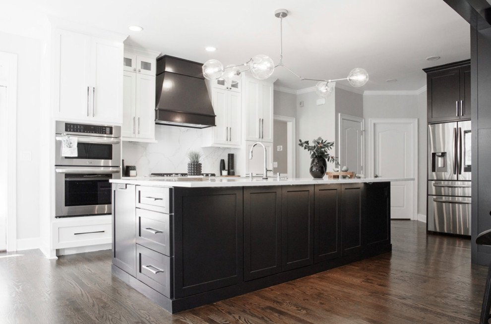 Design ideas for a large contemporary galley kitchen pantry in Atlanta with an undermount sink, shaker cabinets, black cabinets, quartz benchtops, grey splashback, stone slab splashback, panelled appliances, with island and grey benchtop.