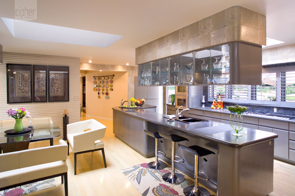 Mid-sized transitional u-shaped light wood floor and yellow floor eat-in kitchen photo with glass-front cabinets, gray cabinets, solid surface countertops, blue backsplash, beige walls, an island, a drop-in sink, mosaic tile backsplash and paneled appliances