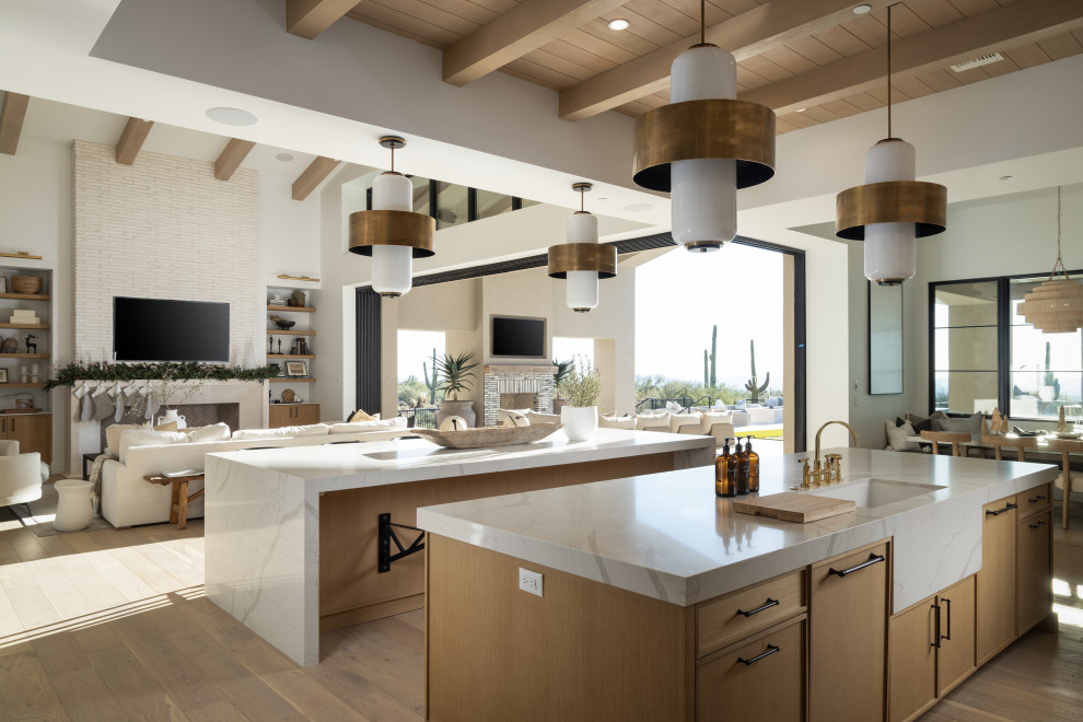 Inspiration for a large transitional galley light wood floor, beige floor and wood ceiling open concept kitchen remodel in Phoenix with an undermount sink, beaded inset cabinets, light wood cabinets, quartz countertops, white backsplash, stone slab backsplash, stainless steel appliances, two islands and white countertops