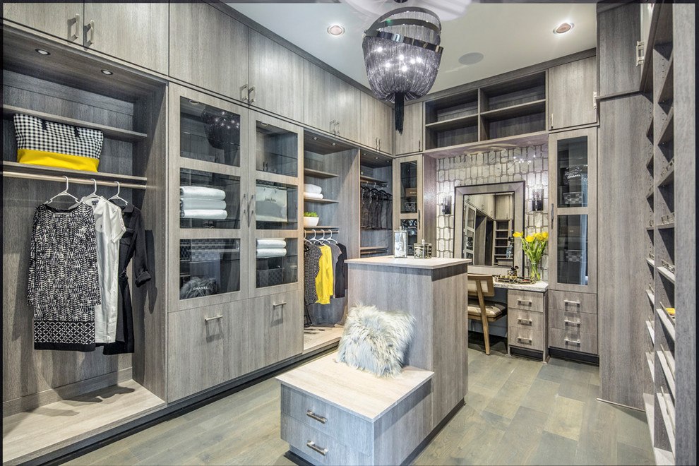 Design ideas for a large contemporary women's dressing room in Denver with flat-panel cabinets, grey cabinets, light hardwood floors and grey floor.