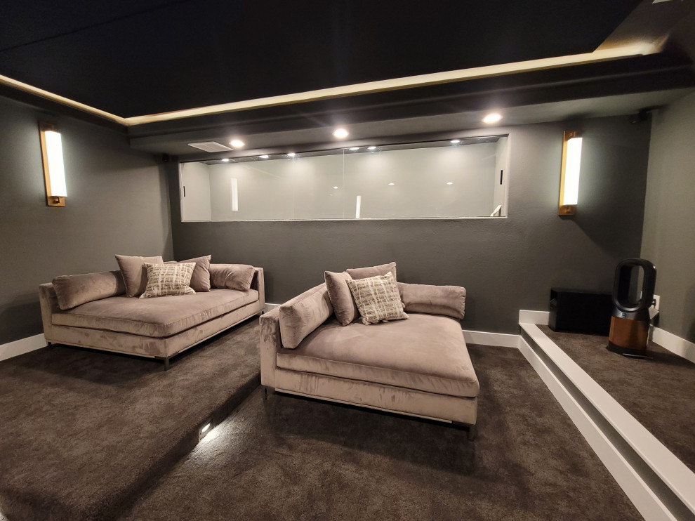 Design ideas for a large contemporary home cinema in Austin with grey walls, carpet, a wall mounted tv and grey floors.