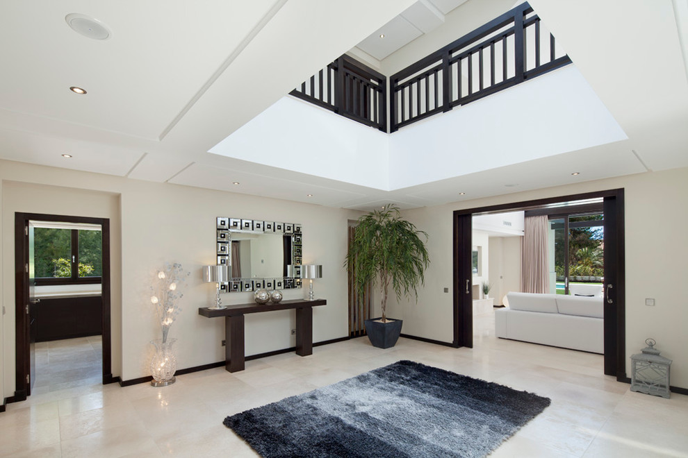 Large contemporary foyer in Other with white walls.