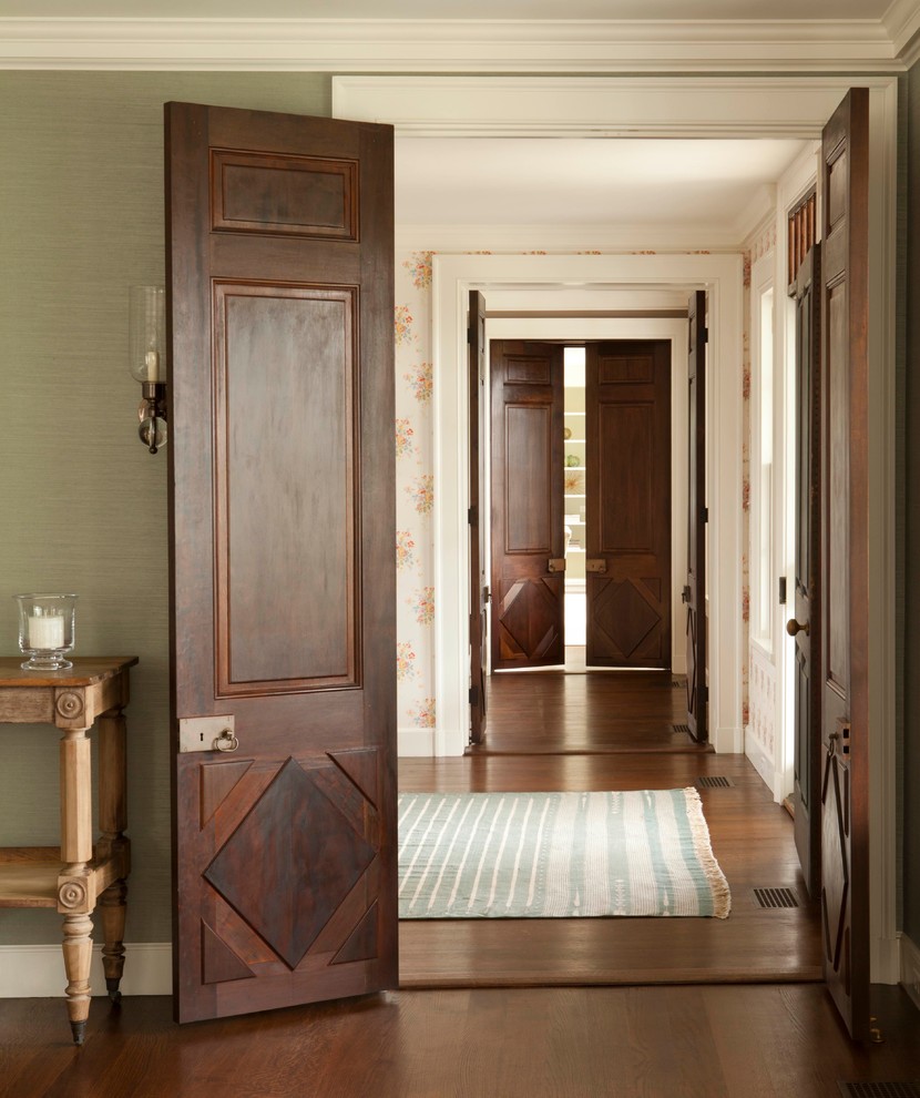 Photo of a large beach style hallway in Boston with green walls and dark hardwood floors.