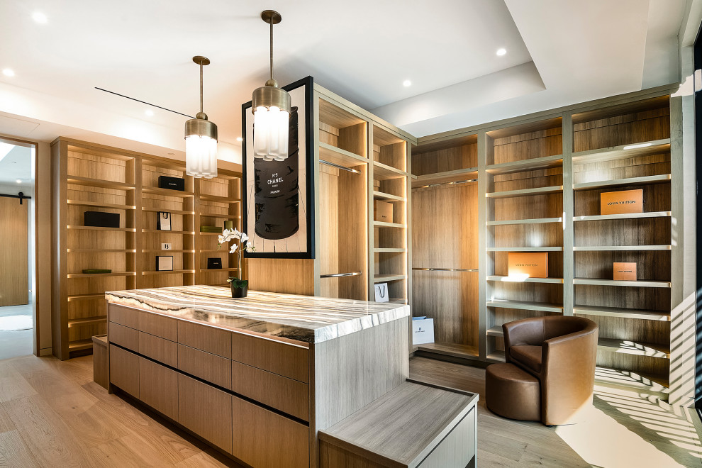 Dressing room - large contemporary gender-neutral light wood floor and beige floor dressing room idea in Los Angeles with open cabinets and light wood cabinets