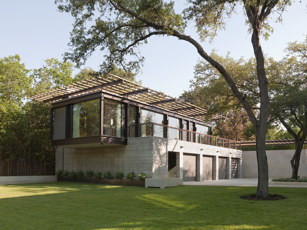 Design ideas for a mid-sized modern two-storey concrete brown apartment exterior in Austin with a flat roof.