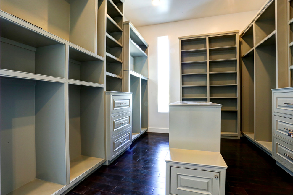 Inspiration for a large transitional gender-neutral walk-in wardrobe in Houston with recessed-panel cabinets, green cabinets and dark hardwood floors.