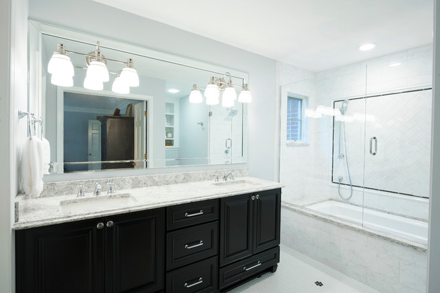 traditional master bathroom with dark cabinets and white