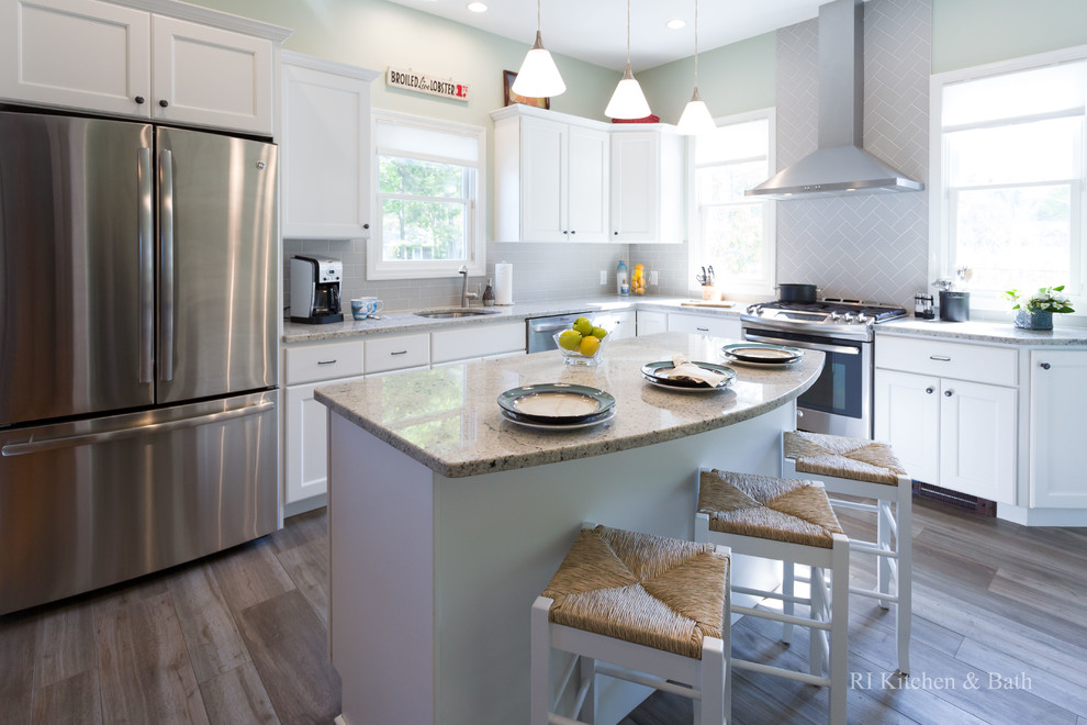 Large transitional l-shaped porcelain tile eat-in kitchen photo in Providence with an undermount sink, recessed-panel cabinets, white cabinets, granite countertops, gray backsplash, ceramic backsplash, stainless steel appliances, green walls and an island