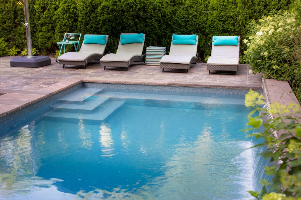 Small transitional backyard stone and rectangular pool fountain photo in Toronto