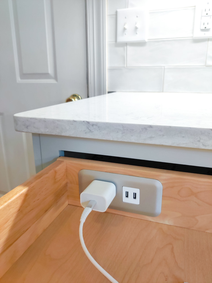Eat-in kitchen - mid-sized transitional l-shaped medium tone wood floor and brown floor eat-in kitchen idea with a farmhouse sink, shaker cabinets, gray cabinets, quartz countertops, white backsplash, porcelain backsplash, stainless steel appliances, an island and white countertops