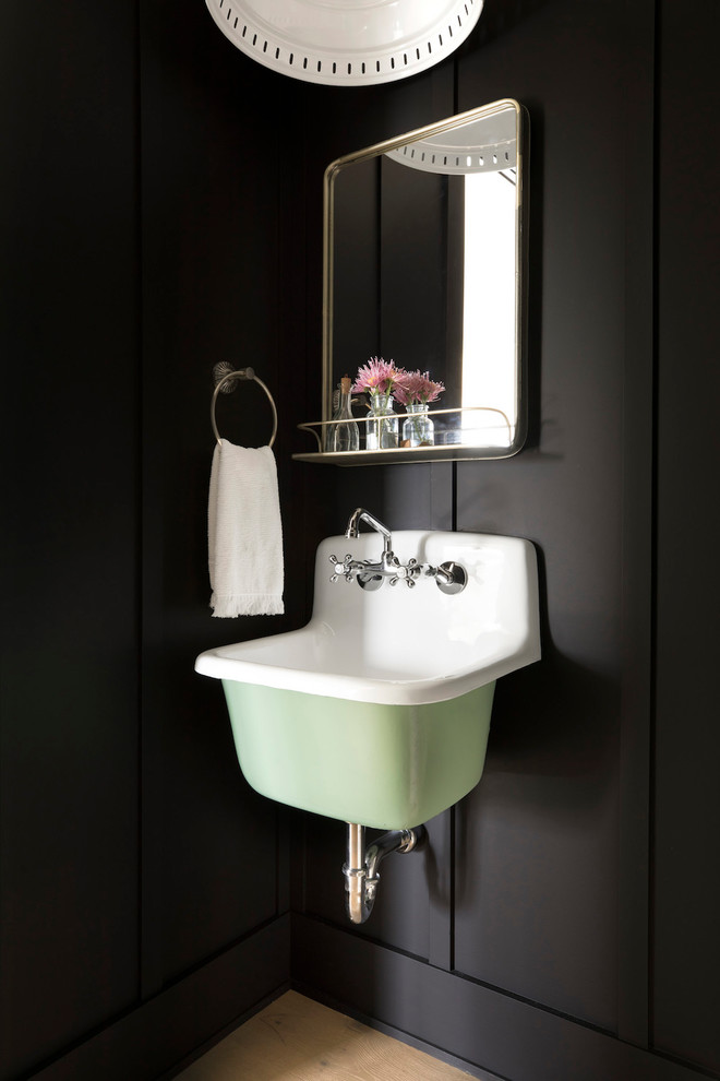 Photo of a country powder room in Minneapolis with black walls and a wall-mount sink.