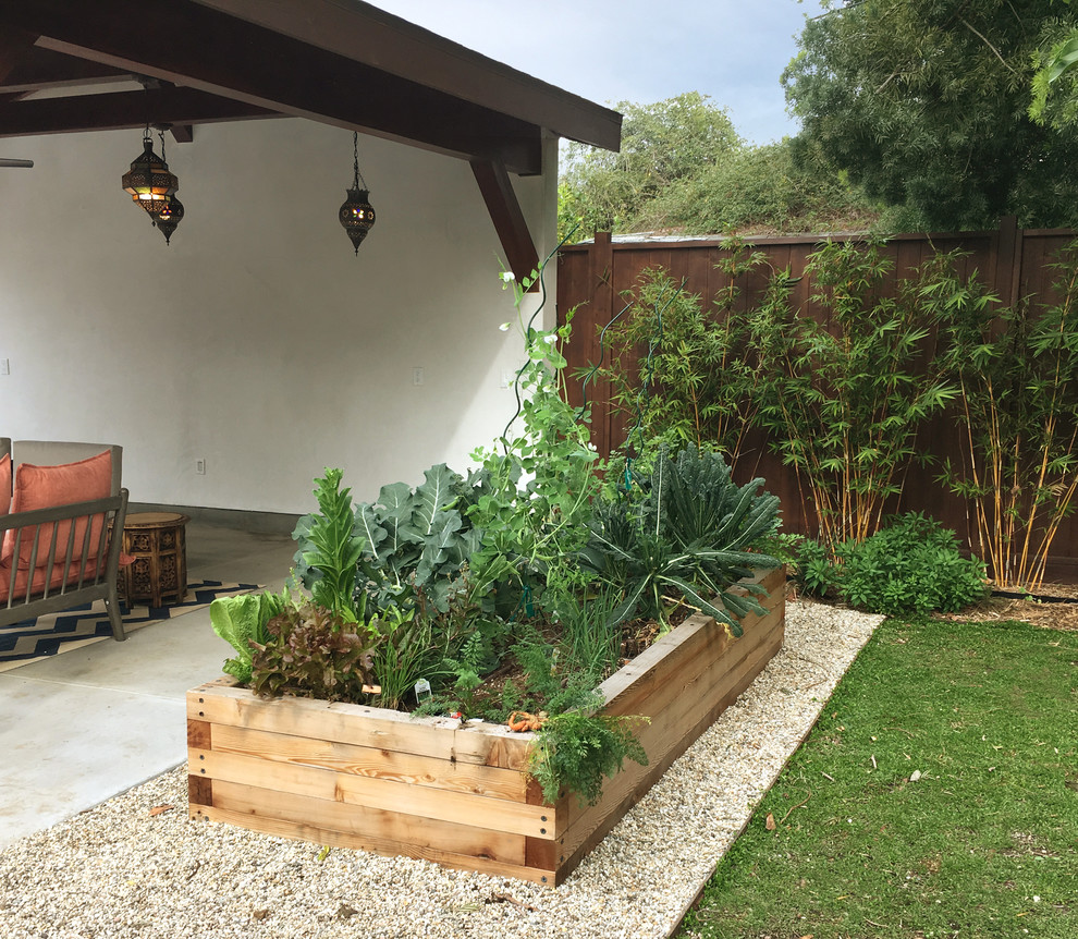 Large eclectic backyard full sun xeriscape in Los Angeles with a vegetable garden and concrete pavers for summer.